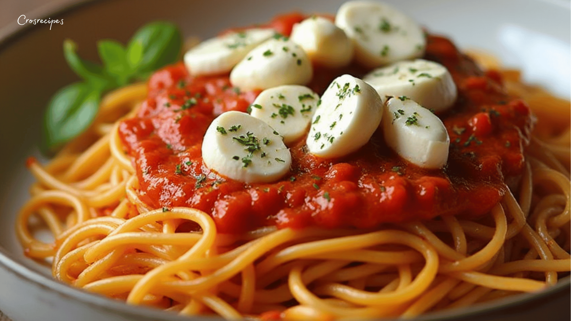 Spaghetti à la crème de poivron rouge et mozzarella, garnis de basilic frais.