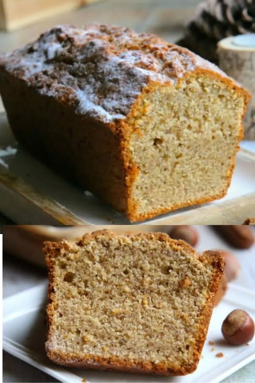 Cake aux noisettes ultra moelleux, doré et fondant, saupoudré de sucre glace, présenté sur une assiette avec une texture aérienne et gourmande.