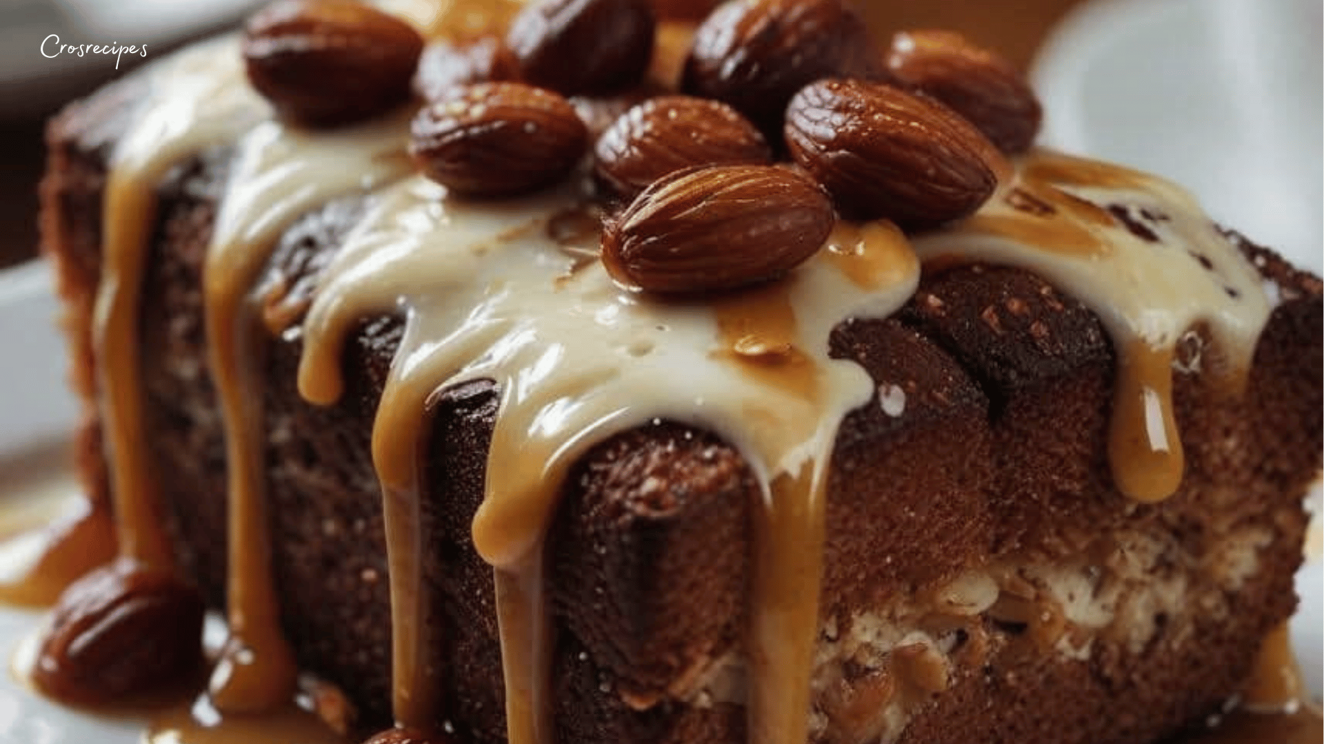 Coussins moelleux à la ricotta et aux amandes, dorés au four, arrosés de miel et saupoudrés d’amandes effilées, servis sur une assiette élégante.