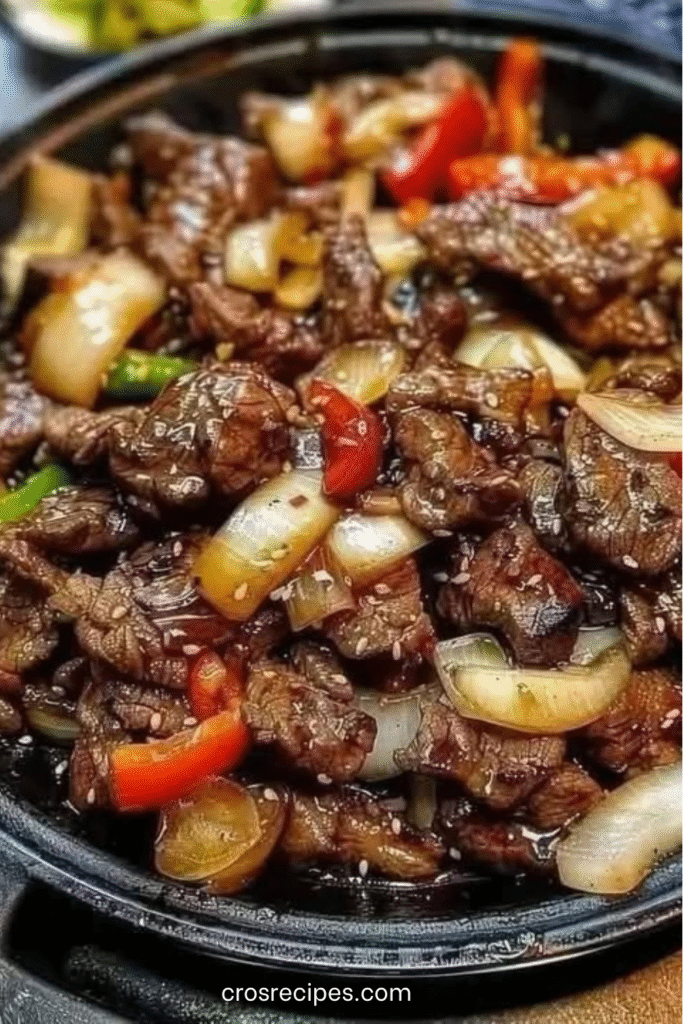 Lamelles de bœuf sautées au wok avec poivrons, oignons et sauce au poivre chinois servies sur du riz jasmin.