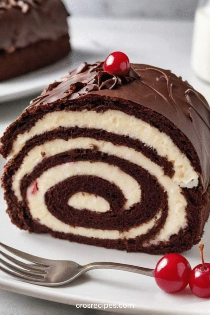 Roulade Forêt-Noire au chocolat garnie de crème fouettée et de cerises, décorée de copeaux de chocolat.