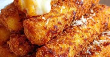 Bâtonnets de mozzarella panés et dorés, croustillants à l’extérieur et au fromage filant à l’intérieur, servis avec une sauce marinara.