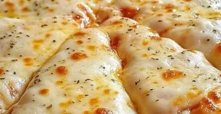 Pizza à l’ail et au fromage dorée au four avec mozzarella fondue, parmesan et herbes séchées sur pâte croustillante