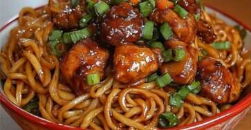 Nouilles sautées au wok avec boulettes de poulet caramélisées, sauce soja brillante, oignons verts frais et légumes croquants