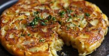 Omelette espagnole tortilla de patatas dorée et épaisse, coupée en parts, avec pommes de terre fondantes, œufs moelleux et salade verte.