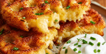 Gaufres salées de pommes de terre très dorées et croustillantes, garnies de fromage fondu et de ciboulette, servies avec une salade fraîche et une sauce au yaourt.